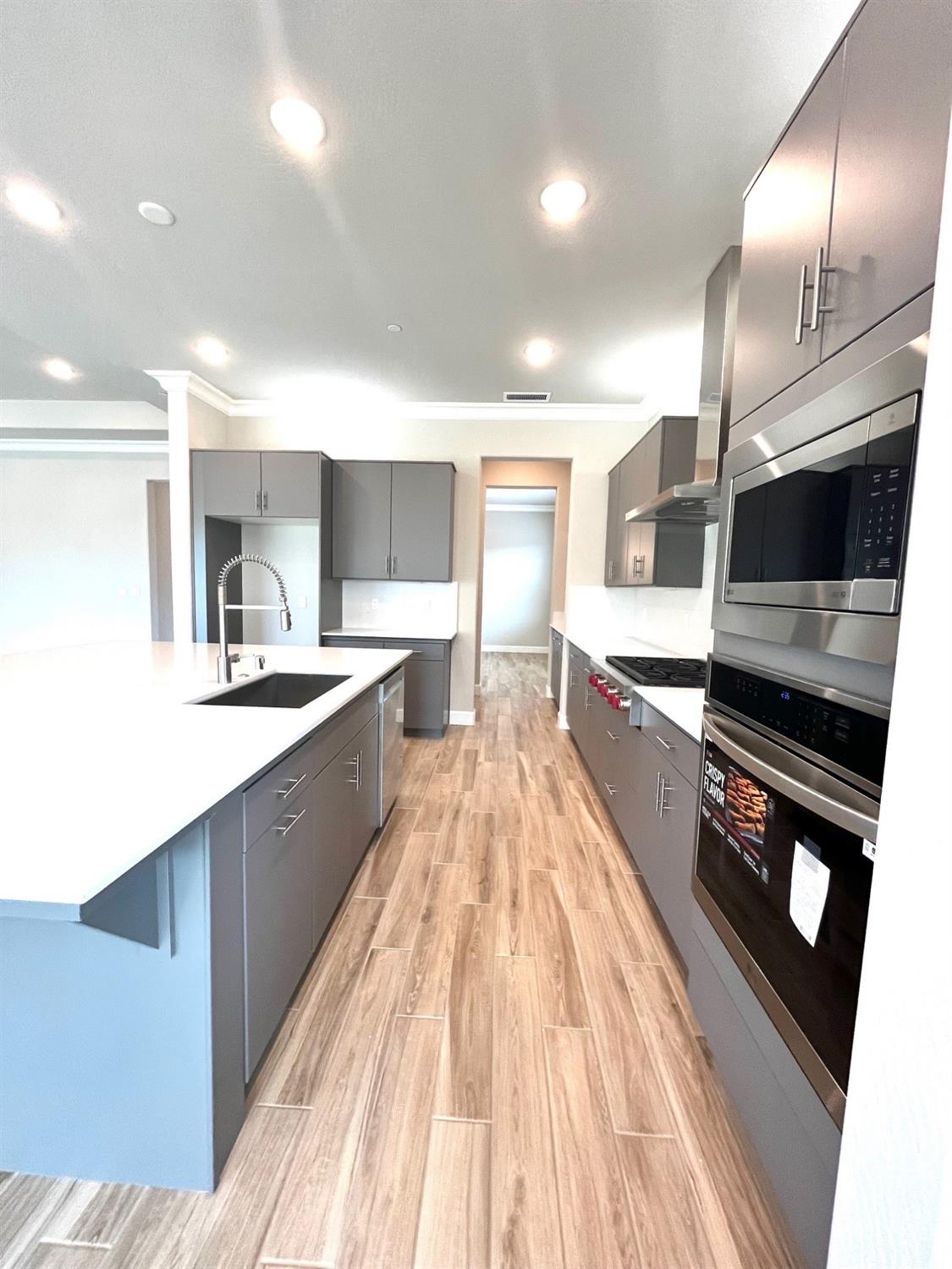 682 Bloom Lane Clovis, CA 93619 - Photo 11 of 30 a large kitchen with stainless steel appliances