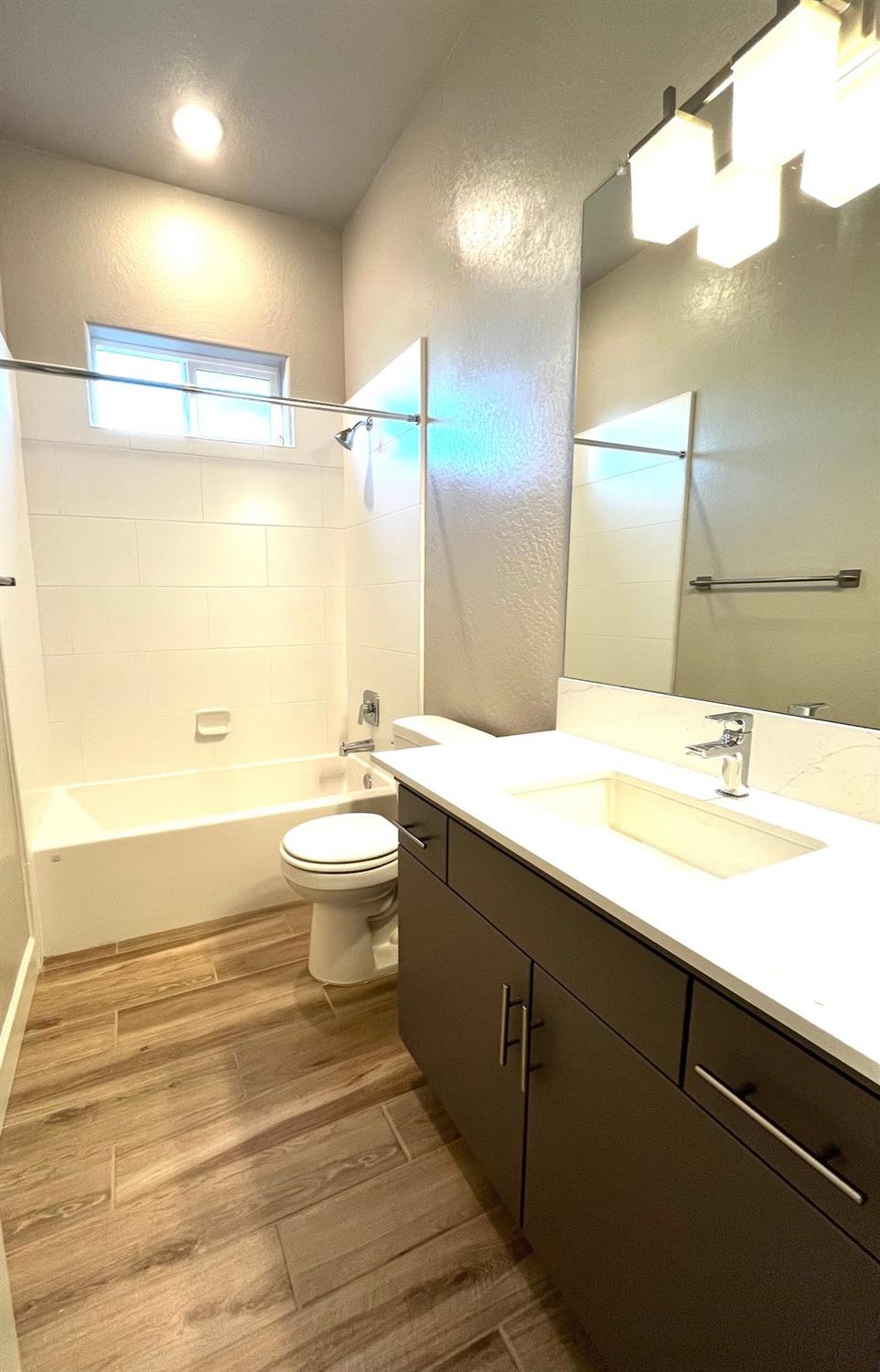 682 Bloom Lane Clovis, CA 93619 - Photo 12 of 30 a bathroom with a double vanity sink toilet and a mirror