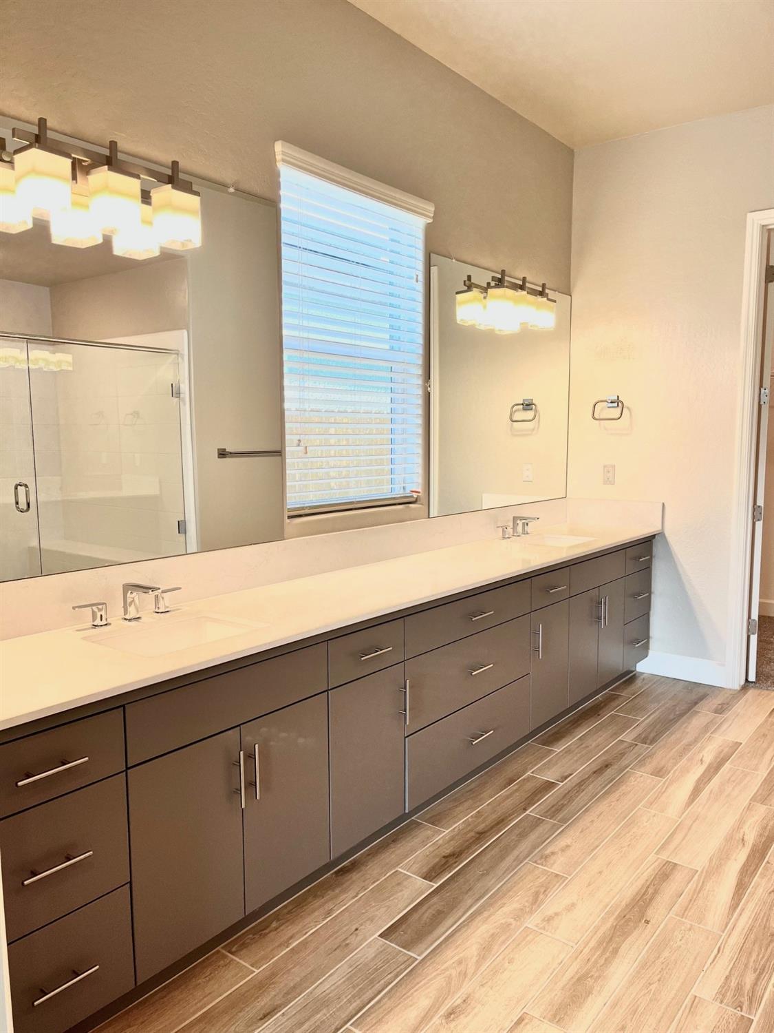 682 Bloom Lane Clovis, CA 93619 - Photo 17 of 30 a bathroom with a double vanity sink and mirror