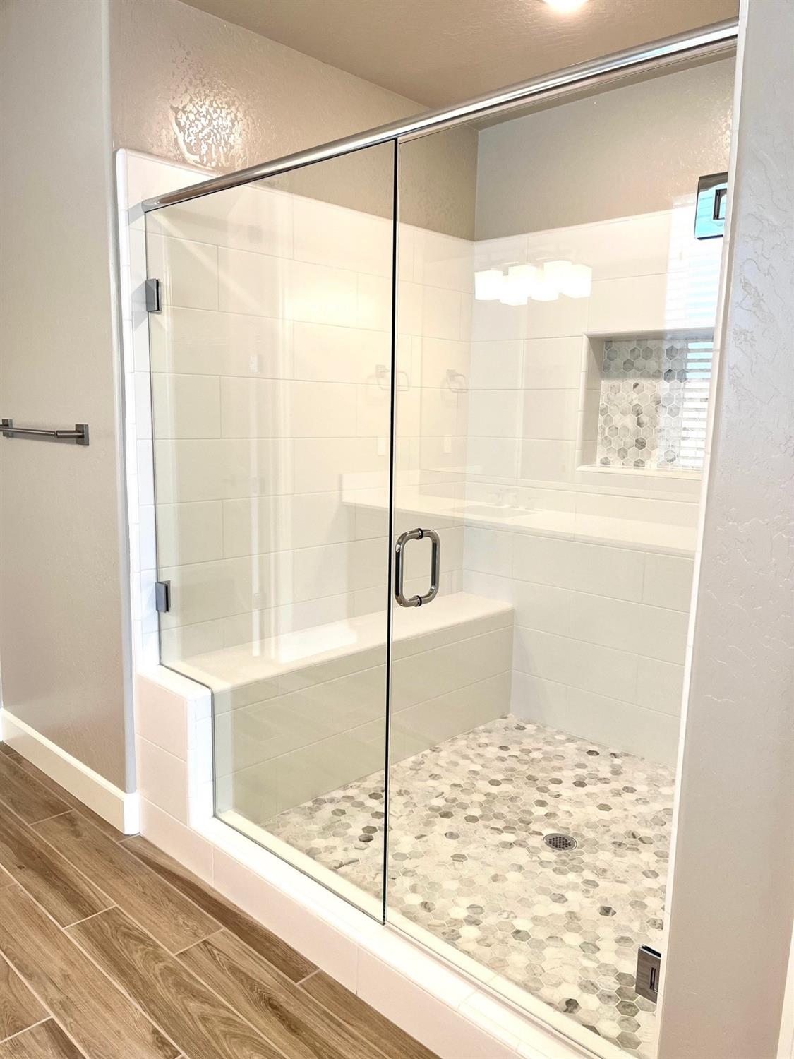 682 Bloom Lane Clovis, CA 93619 - Photo 18 of 30 a bathroom with a glass shower door