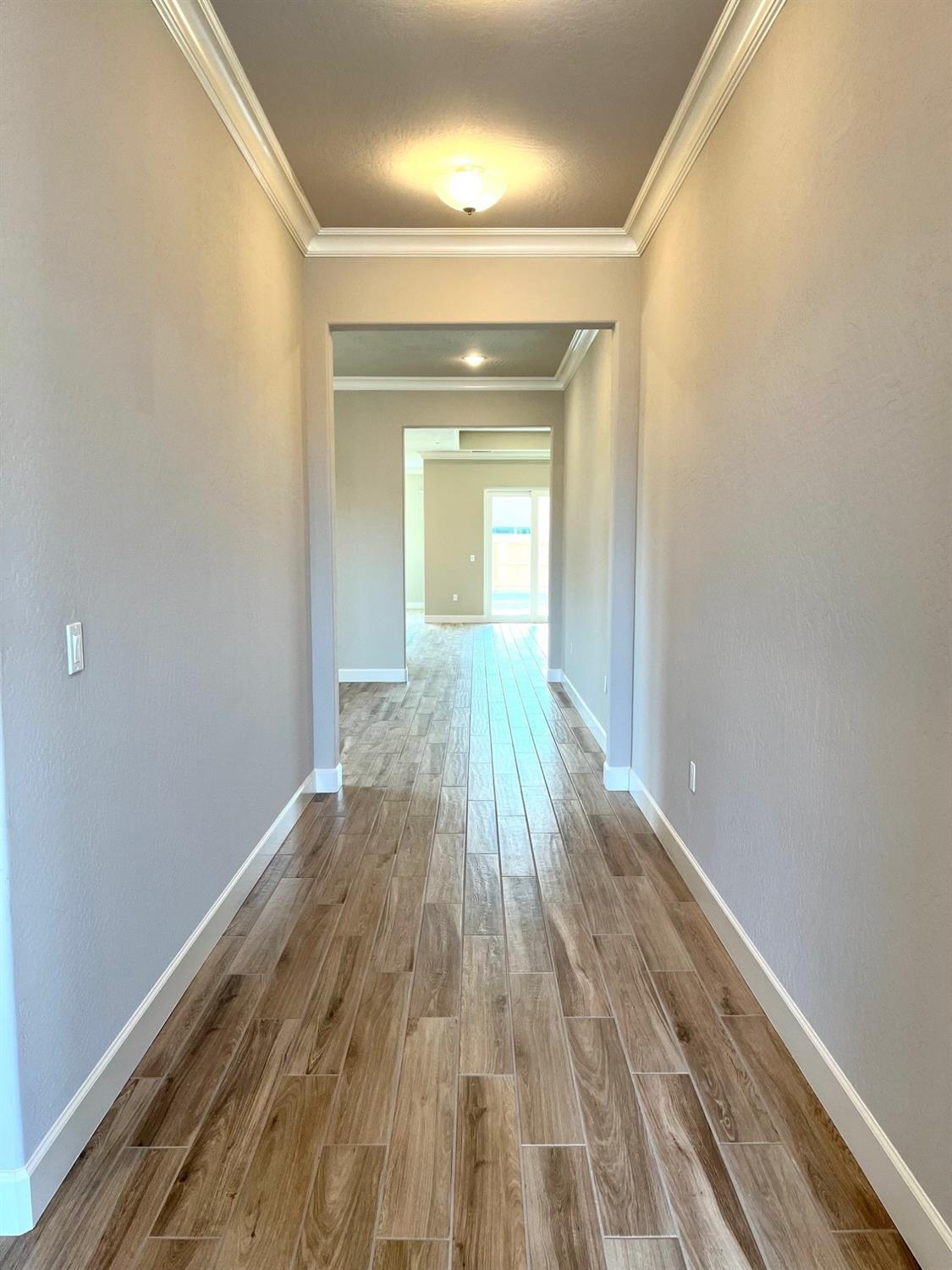 682 Bloom Lane Clovis, CA 93619 - Photo 2 of 30 a view of wooden floor in an empty room
