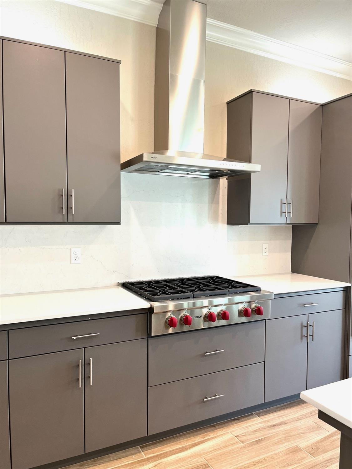 682 Bloom Lane Clovis, CA 93619 - Photo 6 of 30 a kitchen with a cabinets and a stove