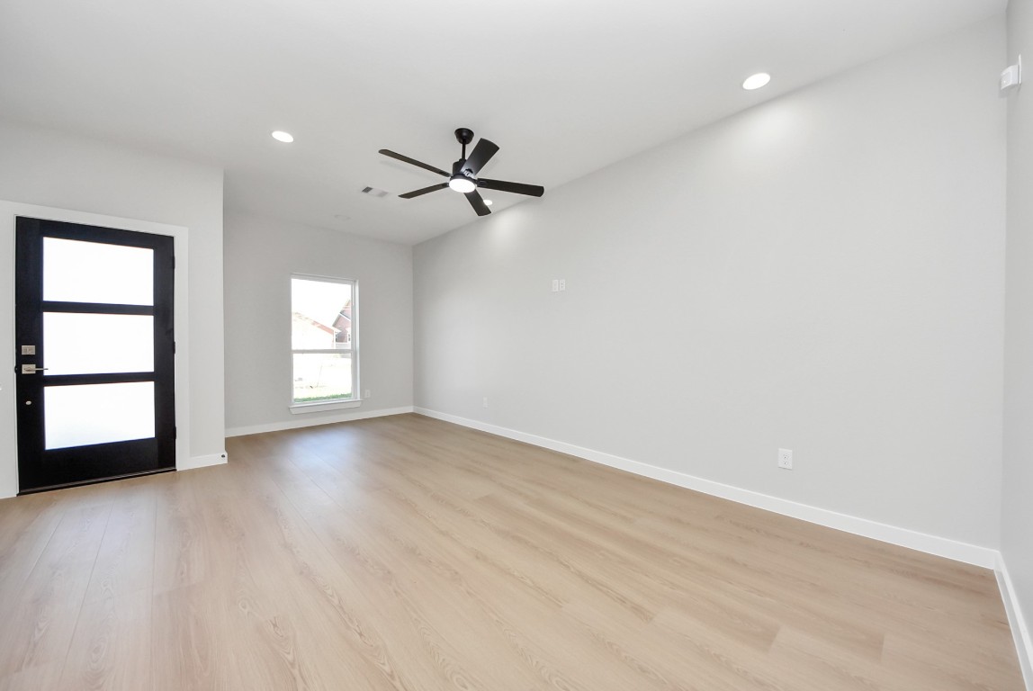9826 Nedwald Street Houston, TX 77029 - Photo 13 of 50 an empty room with windows and ceiling fan