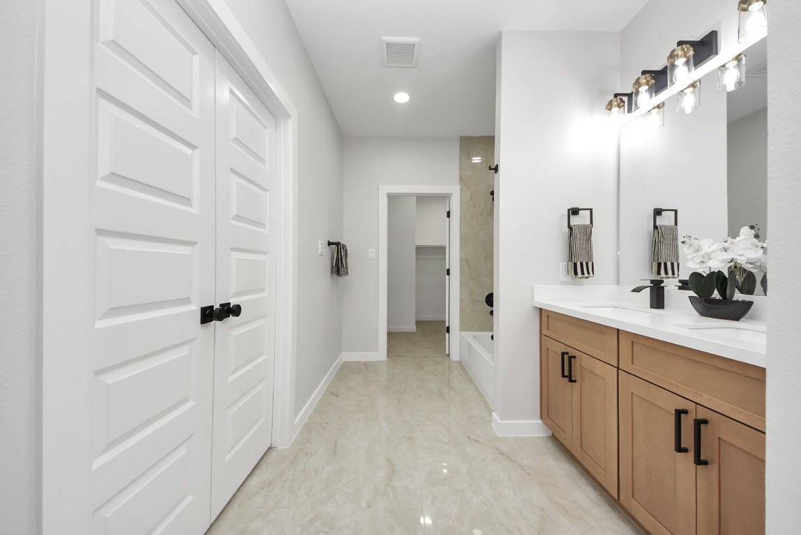 9826 Nedwald Street Houston, TX 77029 - Photo 15 of 50 a spacious bathroom with a shower and a sink