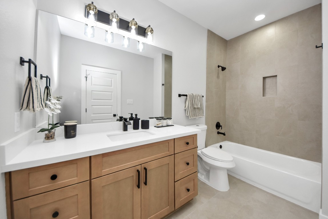 9826 Nedwald Street Houston, TX 77029 - Photo 17 of 50 a bathroom with a double vanity sink a toilet and a bathtub