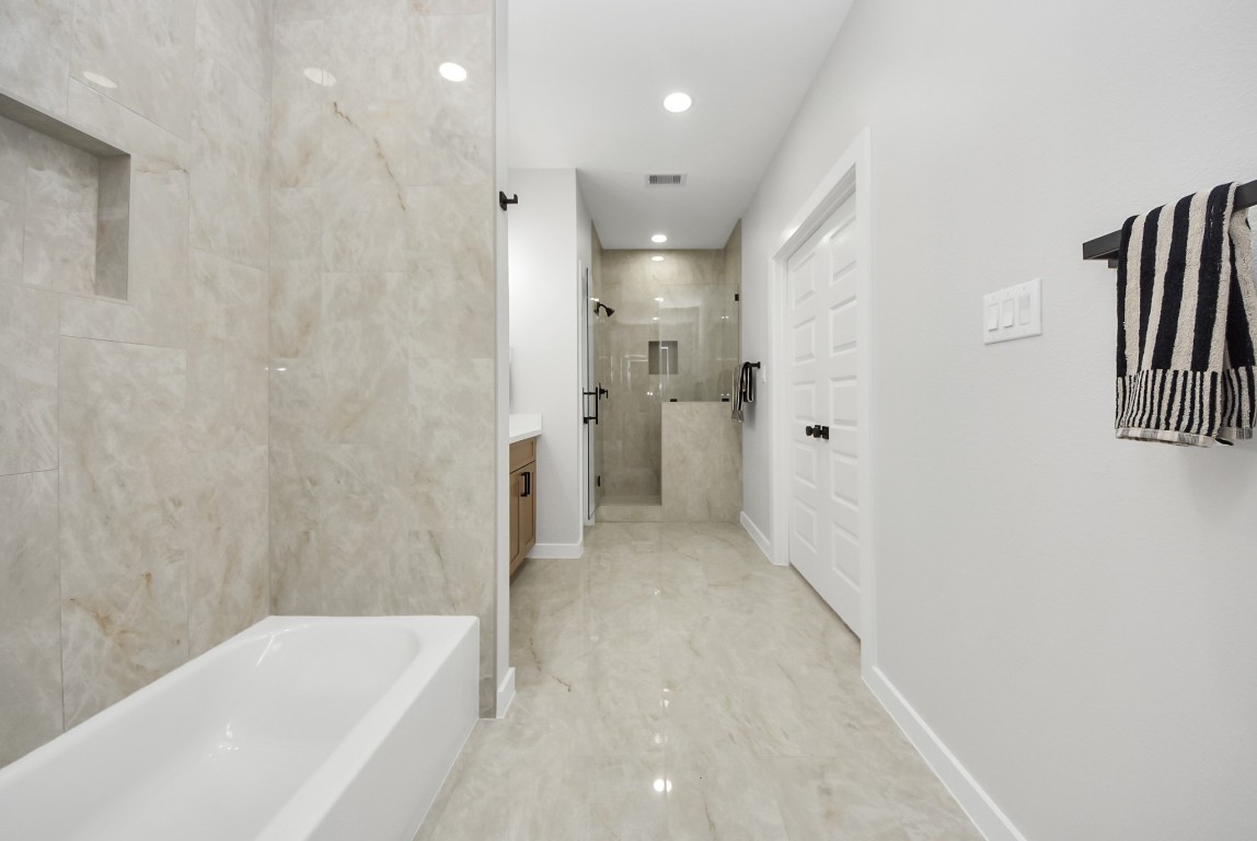 9826 Nedwald Street Houston, TX 77029 - Photo 20 of 50 a bathroom with a bathtub and a shower