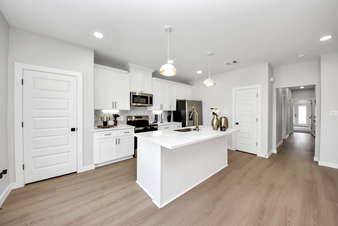 9826 Nedwald Street Houston, TX 77029 - Photo 30 of 50 a view of kitchen with stainless steel appliances refrigerator stove microwave and cabinets