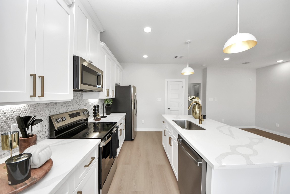 9826 Nedwald Street Houston, TX 77029 - Photo 32 of 50 a kitchen with a sink stove and microwave