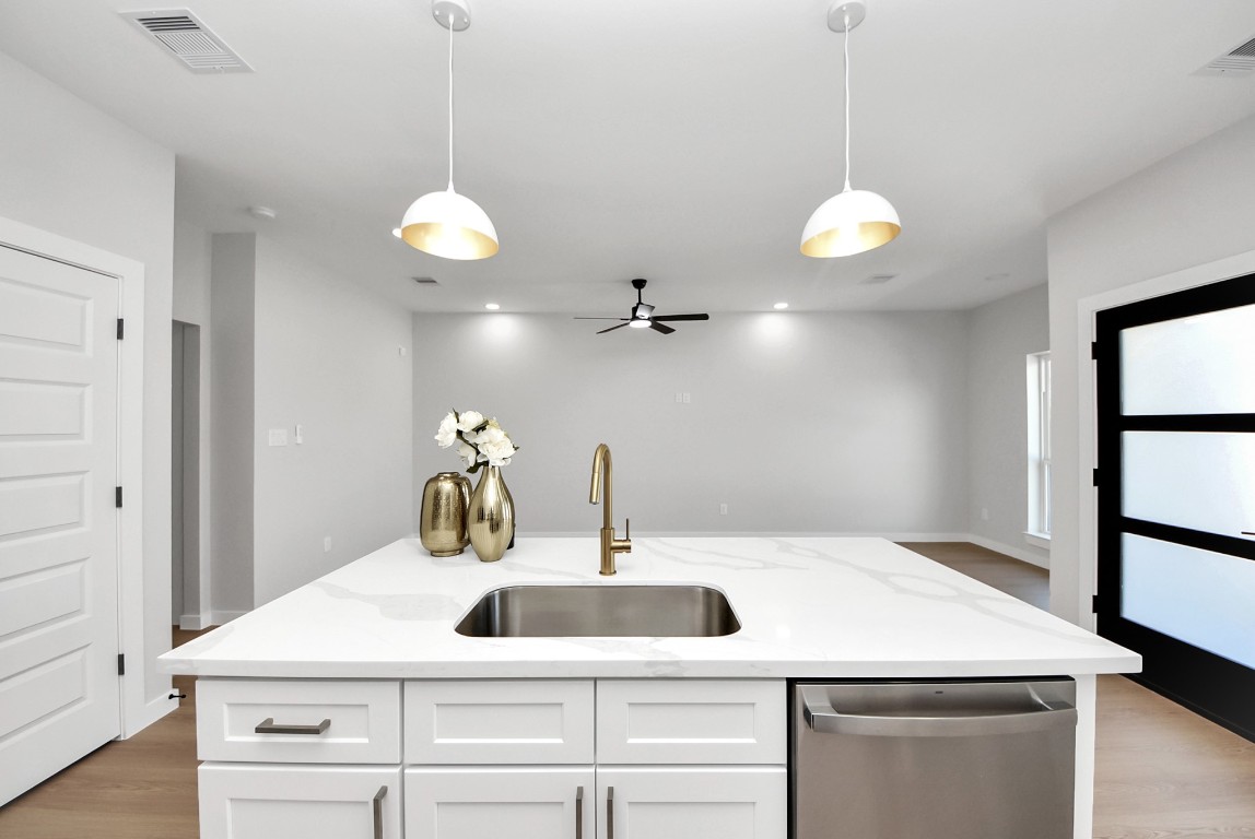 9826 Nedwald Street Houston, TX 77029 - Photo 35 of 50 a kitchen with a sink and chandelier