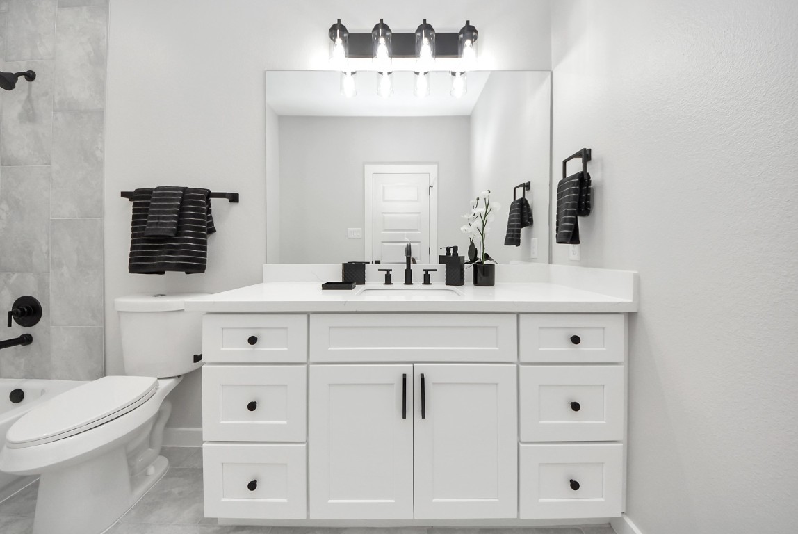 9826 Nedwald Street Houston, TX 77029 - Photo 36 of 50 a bathroom with a sink and a mirror