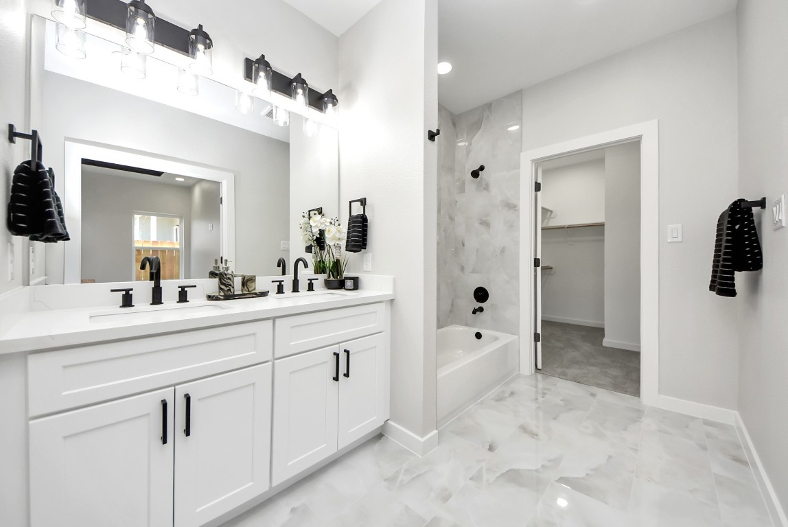 9826 Nedwald Street Houston, TX 77029 - Photo 40 of 50 a spacious bathroom with a shower sink and mirror