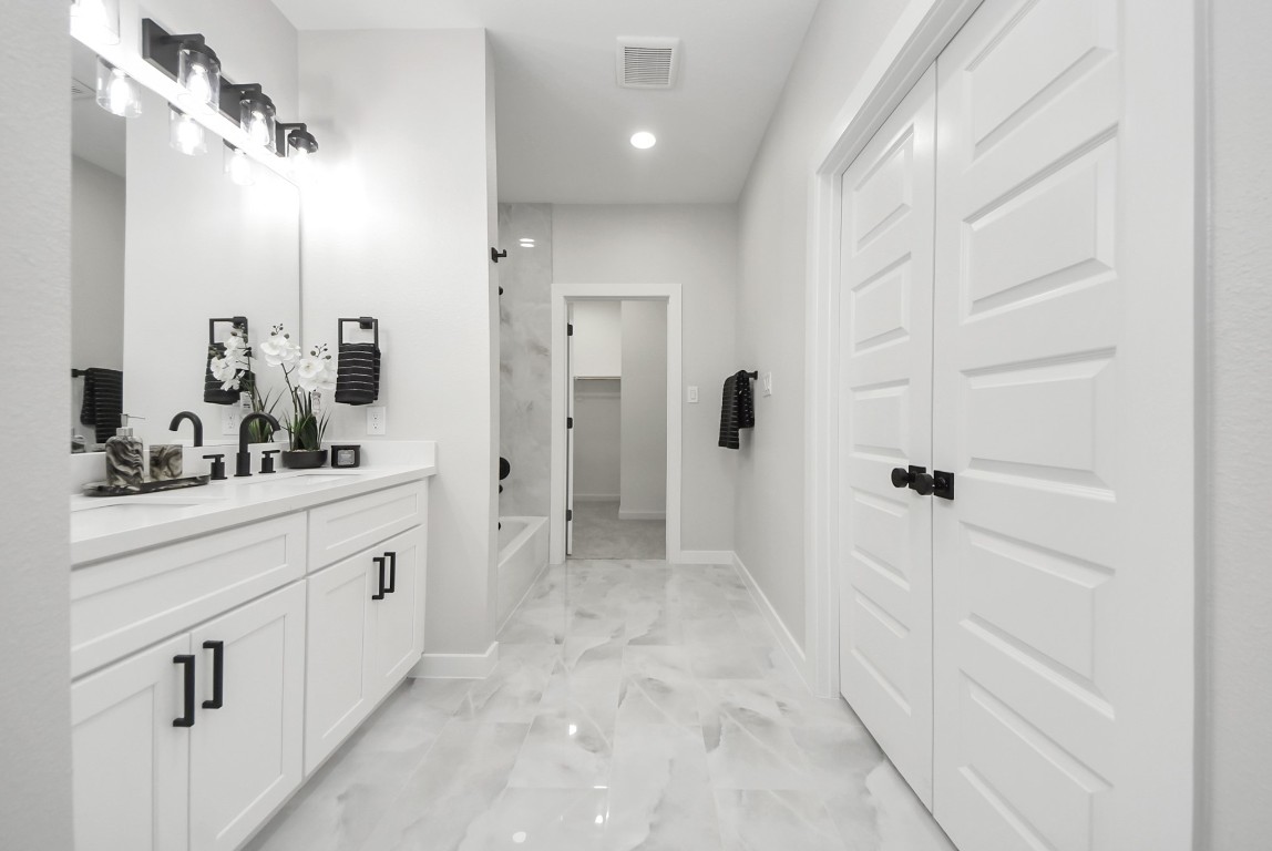 9826 Nedwald Street Houston, TX 77029 - Photo 43 of 50 a bathroom with a sink a mirror and a shower