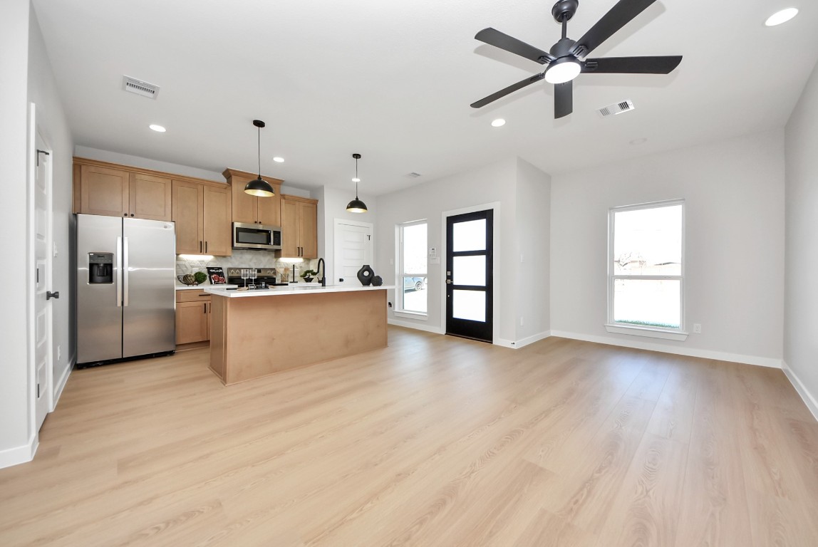 9826 Nedwald Street Houston, TX 77029 - Photo 5 of 50 a kitchen with stainless steel appliances a refrigerator sink and cabinets