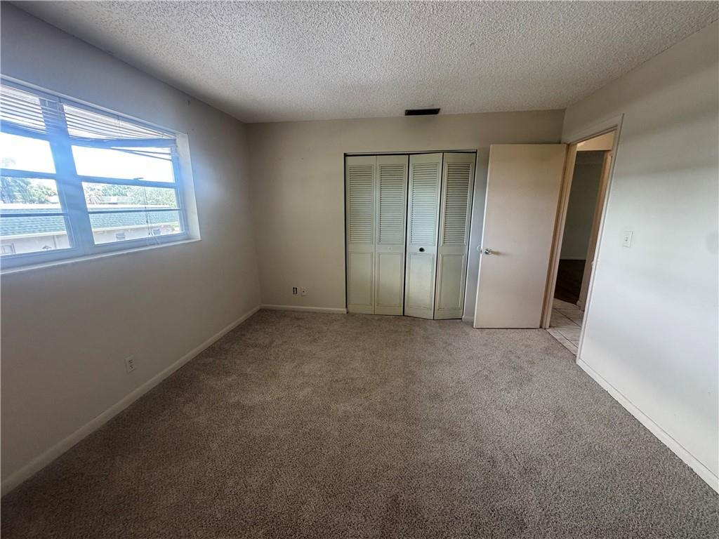 1900 South Kanner Highway, Unit 8205 Stuart, FL 34994 - Photo 14 of 20 an empty room with windows and closet
