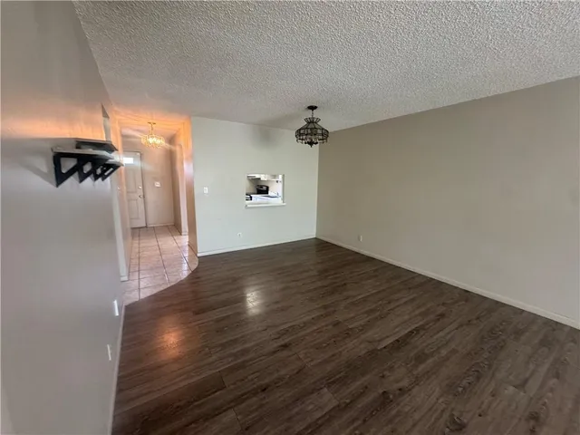 a view of a room with wooden floor