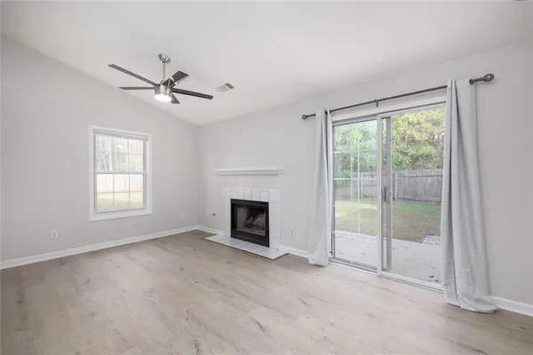 a view of empty room with fireplace and fan