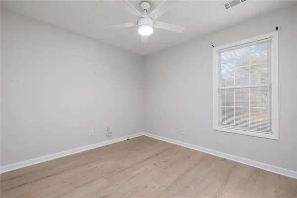 an empty room with a window and closet