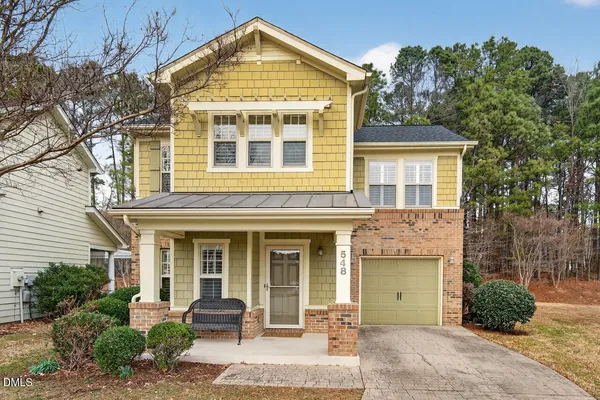 front view of a brick house with a yard