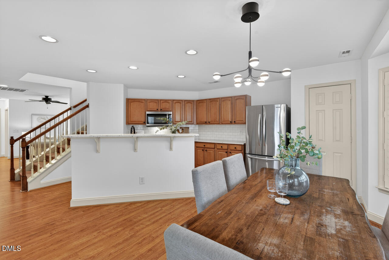 548 Abbey Fields Loop Morrisville, NC 27560 - Photo 12 of 29 a living room with furniture and a chandelier