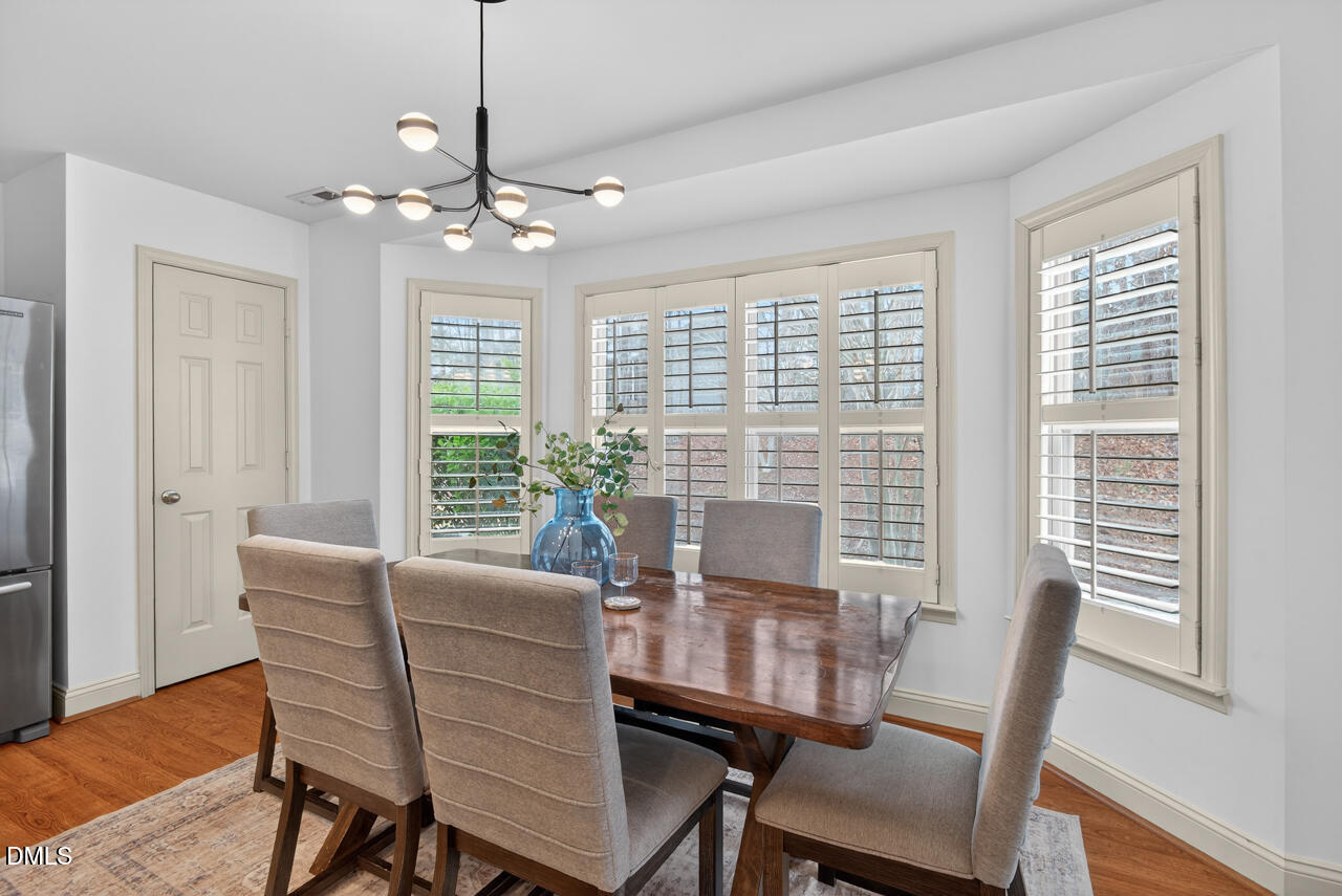 548 Abbey Fields Loop Morrisville, NC 27560 - Photo 13 of 29 a view of a dining room with furniture window and wooden floor