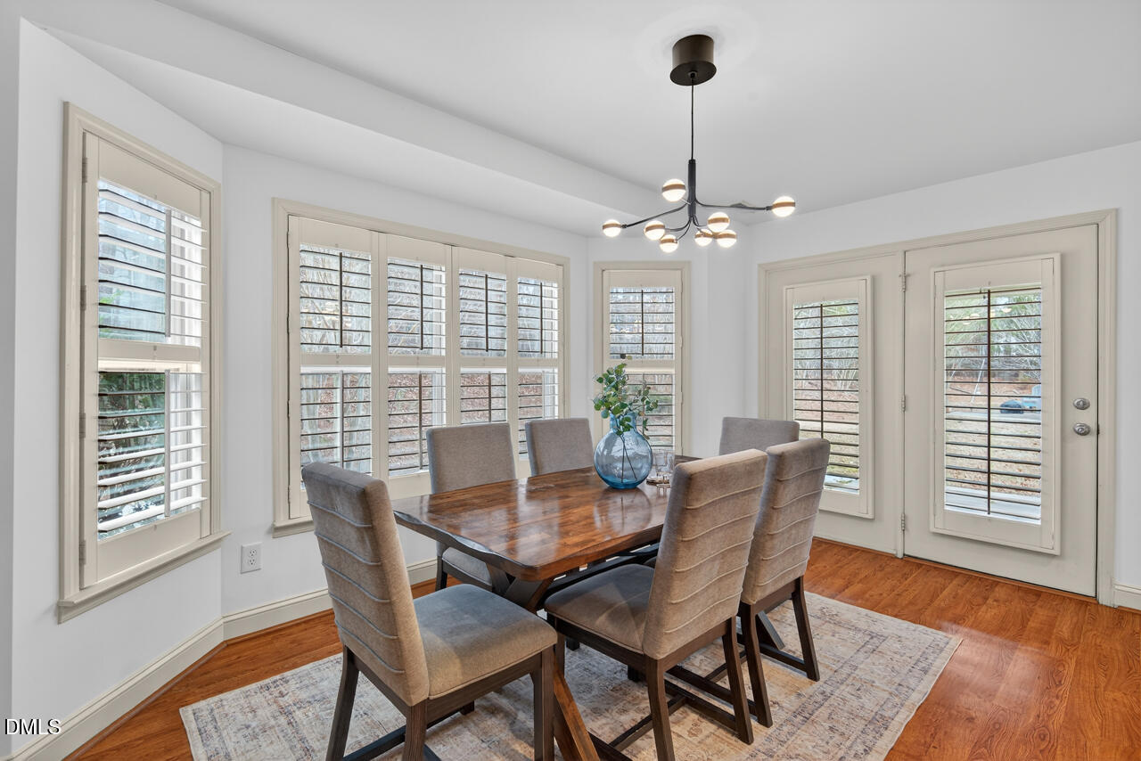 548 Abbey Fields Loop Morrisville, NC 27560 - Photo 14 of 29 a view of a dining room with furniture window and wooden floor