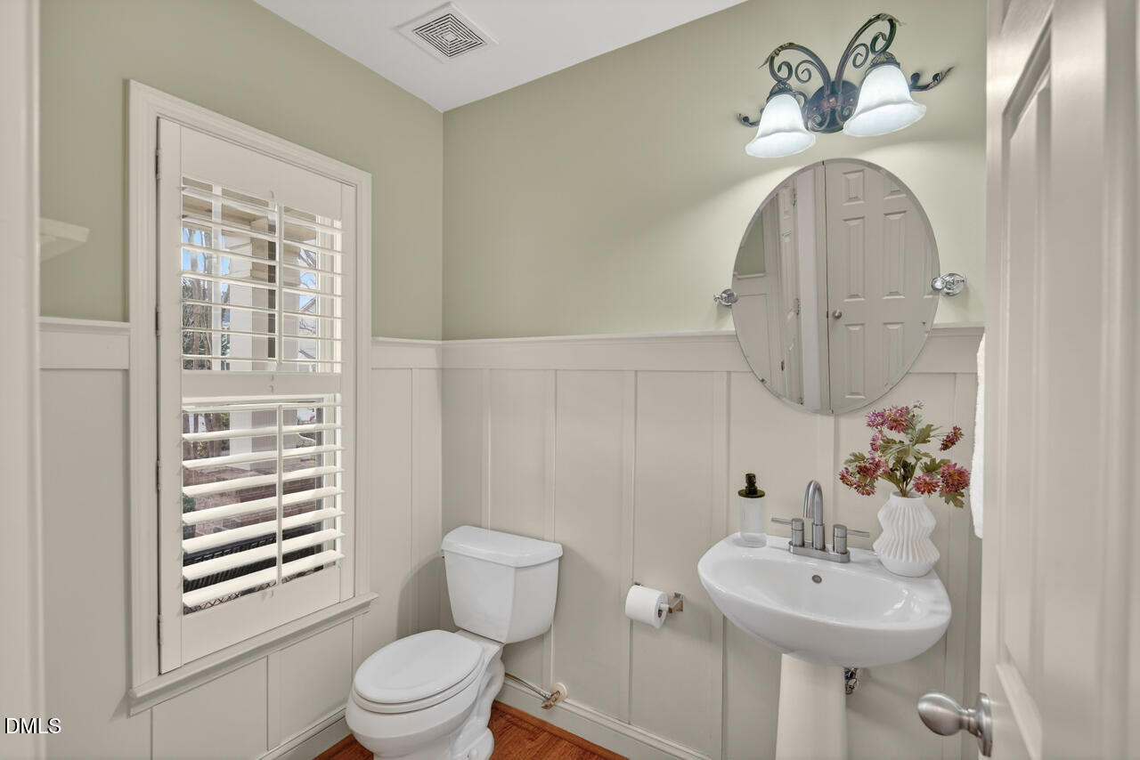 548 Abbey Fields Loop Morrisville, NC 27560 - Photo 15 of 29 a bathroom with a sink a toilet and a mirror