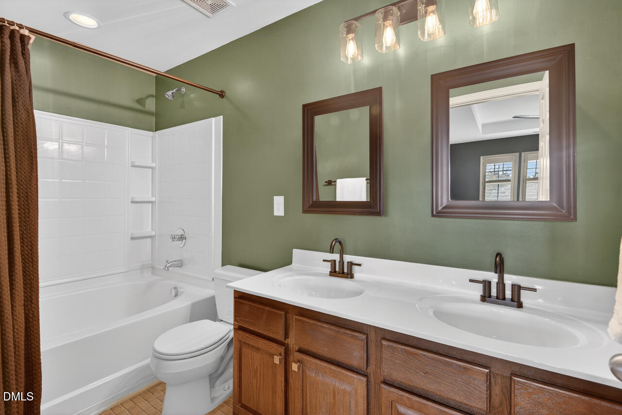 548 Abbey Fields Loop Morrisville, NC 27560 - Photo 19 of 29 a bathroom with a sink a toilet and shower