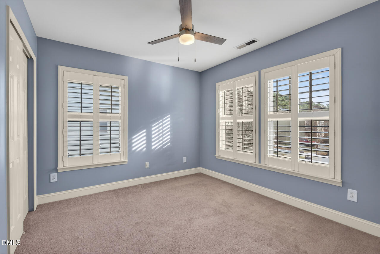 548 Abbey Fields Loop Morrisville, NC 27560 - Photo 20 of 29 a view of an empty room with a window and a kitchen