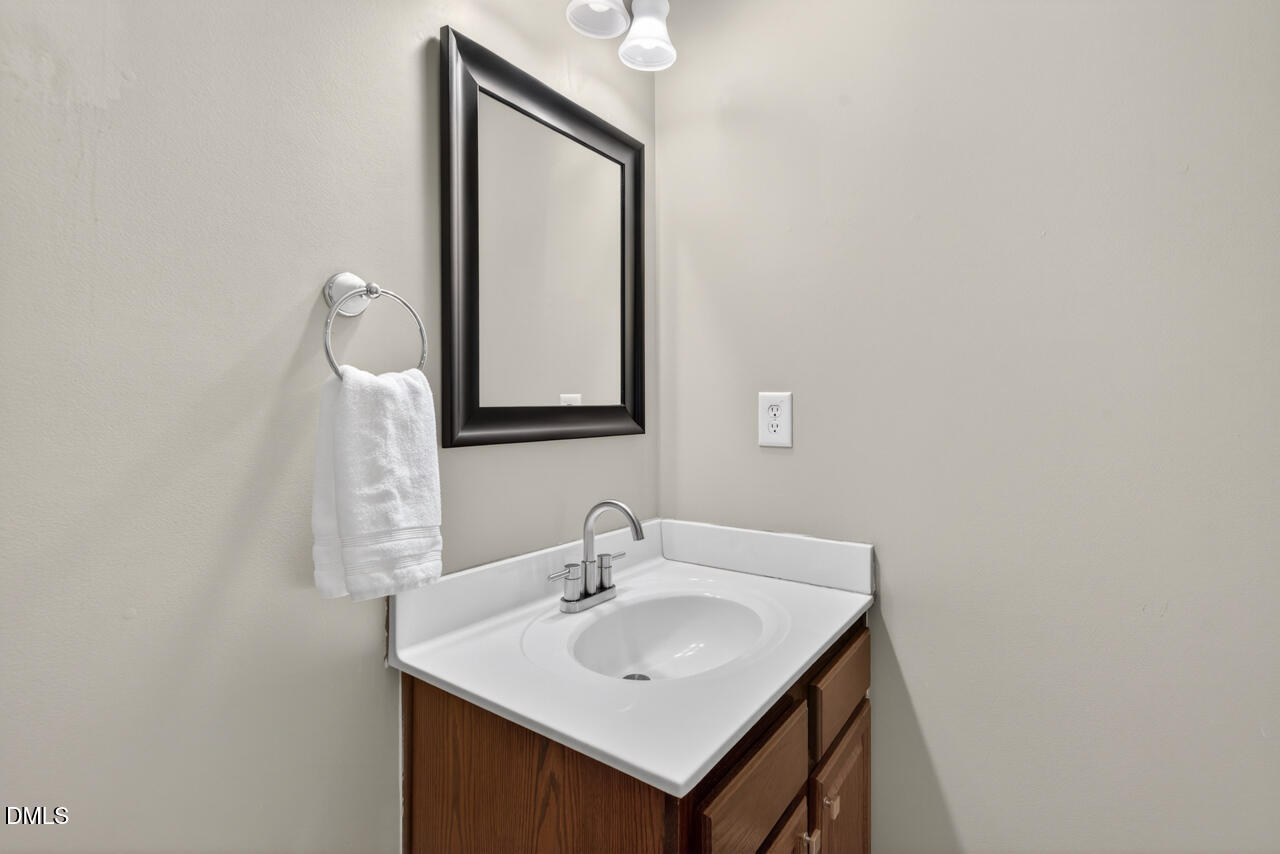 548 Abbey Fields Loop Morrisville, NC 27560 - Photo 23 of 29 a bathroom with a sink and a mirror