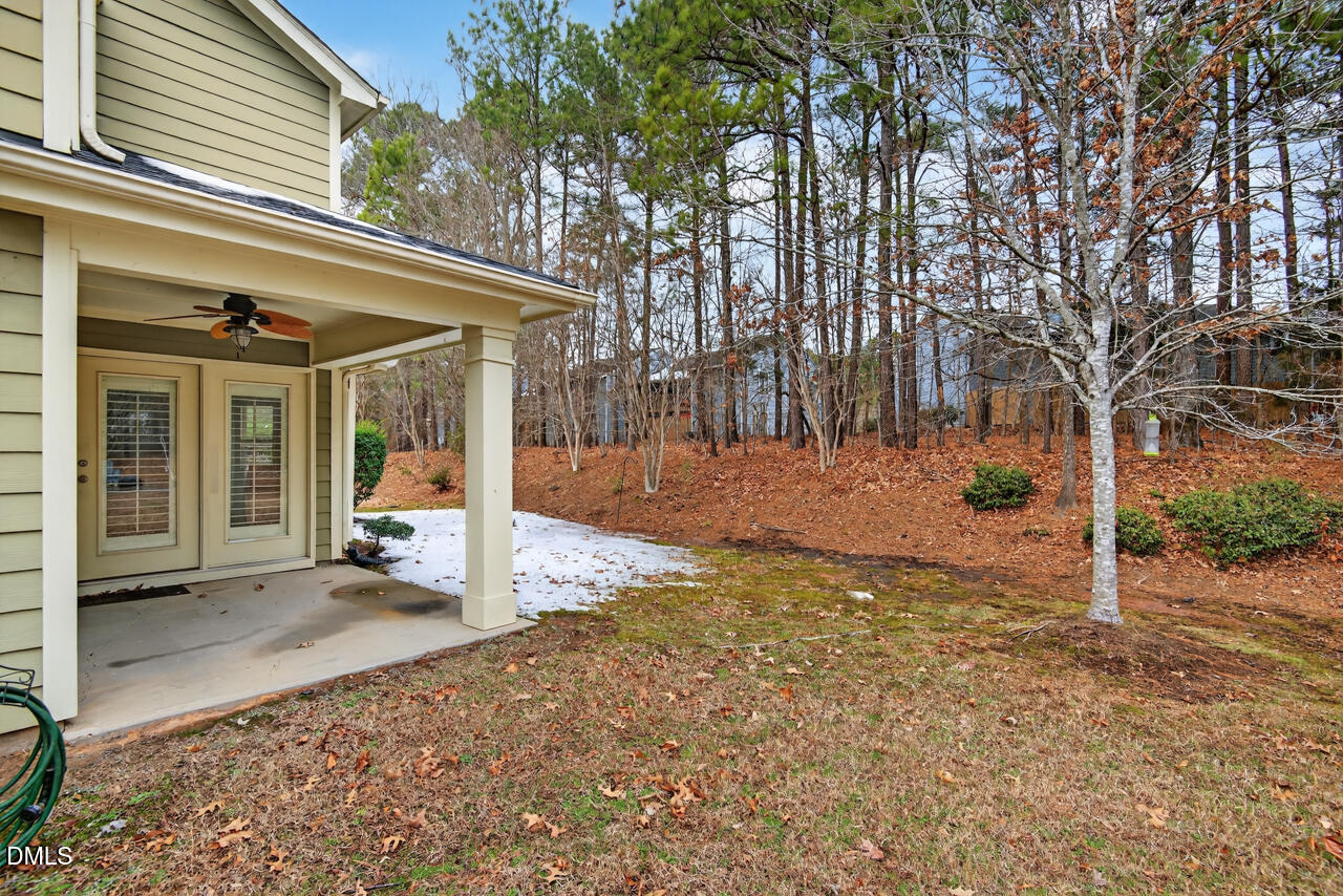 548 Abbey Fields Loop Morrisville, NC 27560 - Photo 27 of 29 a view of a backyard with large tree