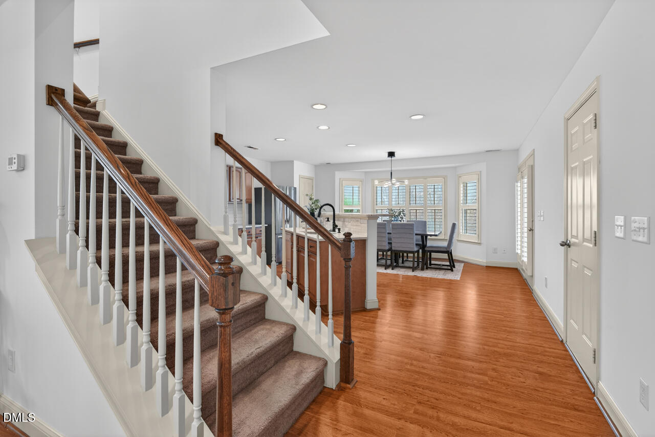 548 Abbey Fields Loop Morrisville, NC 27560 - Photo 8 of 29 a view of entryway and livingroom with wooden floor
