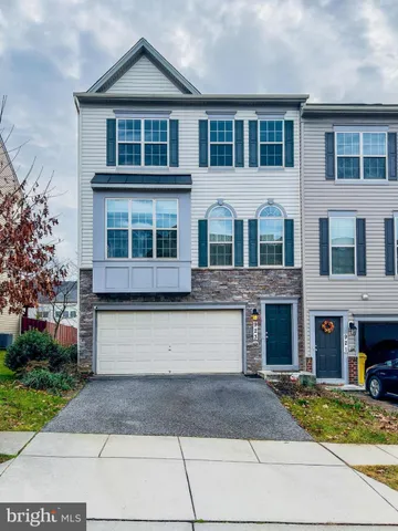 a front view of a house with yard and garage