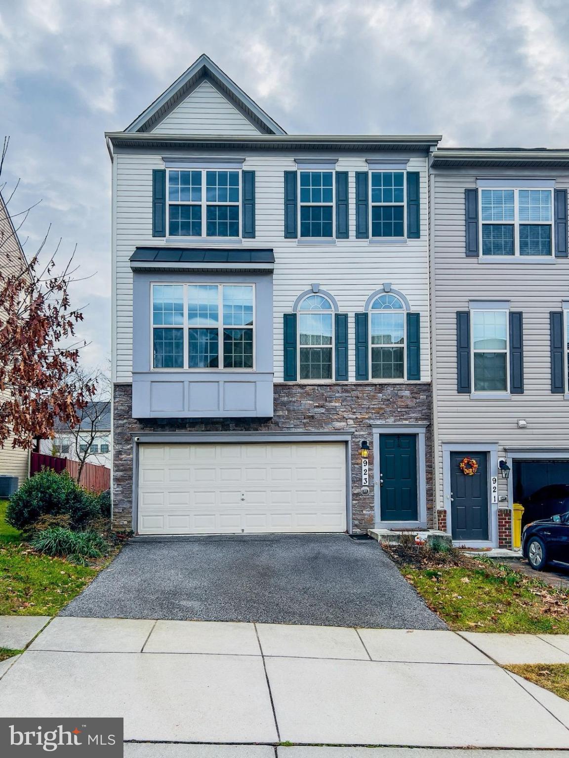a front view of a house with yard and garage