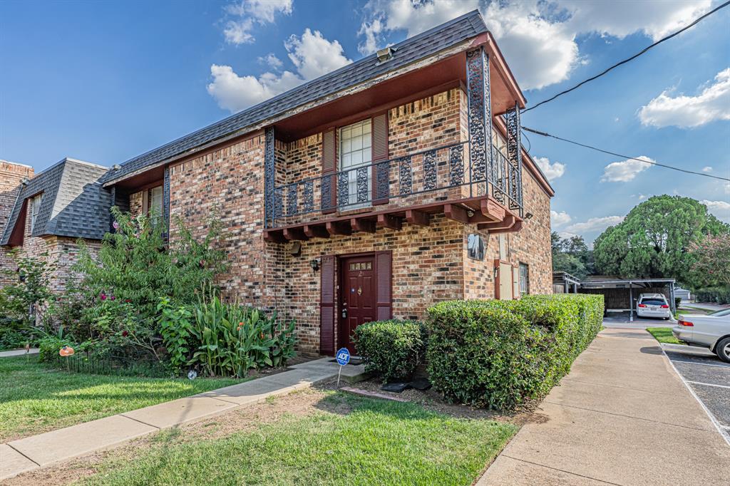 a view of a brick building next to a yard
