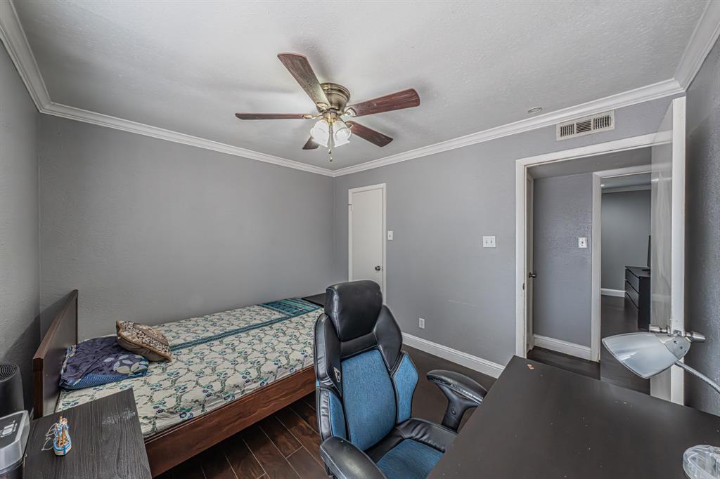 1807 East Grauwyler Road, Unit 124 Irving, TX 75061 - Photo 19 of 22 a bedroom with a bed and a chandelier