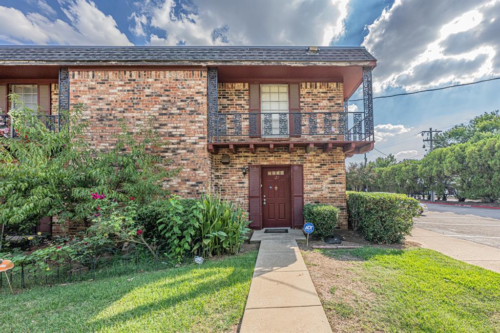 1807 East Grauwyler Road, Unit 124 Irving, TX 75061 - Photo 2 of 22 a front view of a house with a garden
