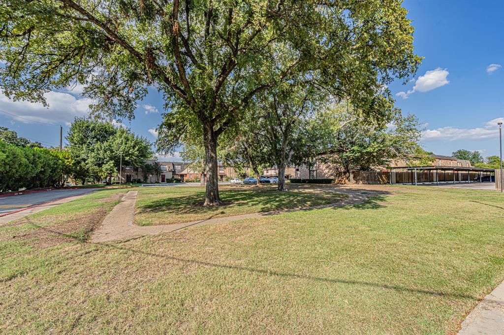 1807 East Grauwyler Road, Unit 124 Irving, TX 75061 - Photo 21 of 22 a view of yard with swimming pool and green space