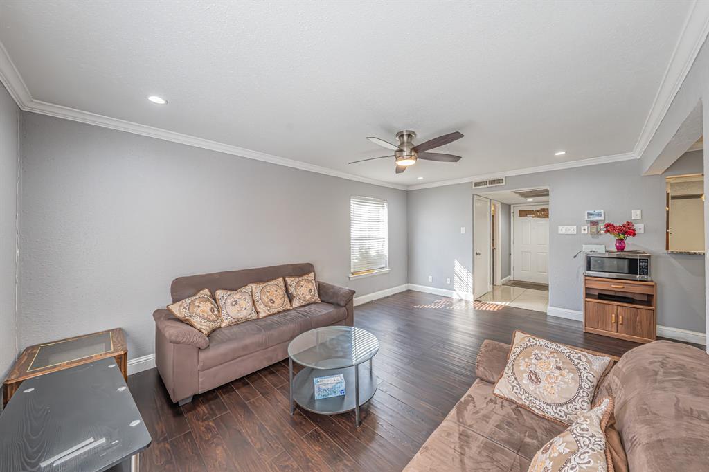 1807 East Grauwyler Road, Unit 124 Irving, TX 75061 - Photo 7 of 22 a living room with furniture and a wooden floor