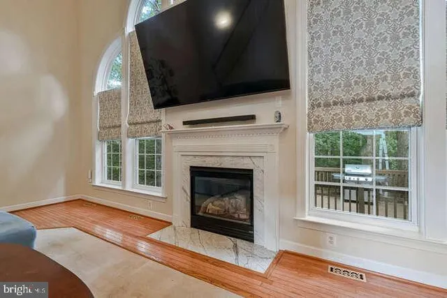 a living room with a fireplace and a flat screen tv