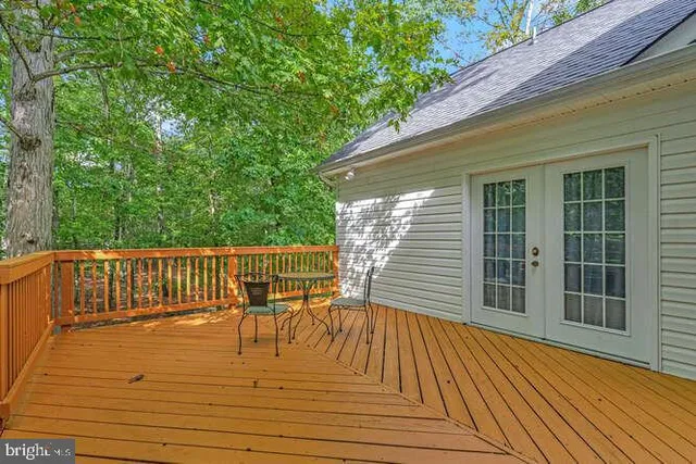 a view of backyard with a wooden deck