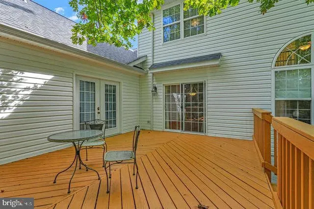 a view of balcony with wooden floor and outdoor seating