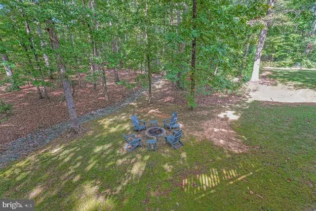 a view of a house with backyard and deck
