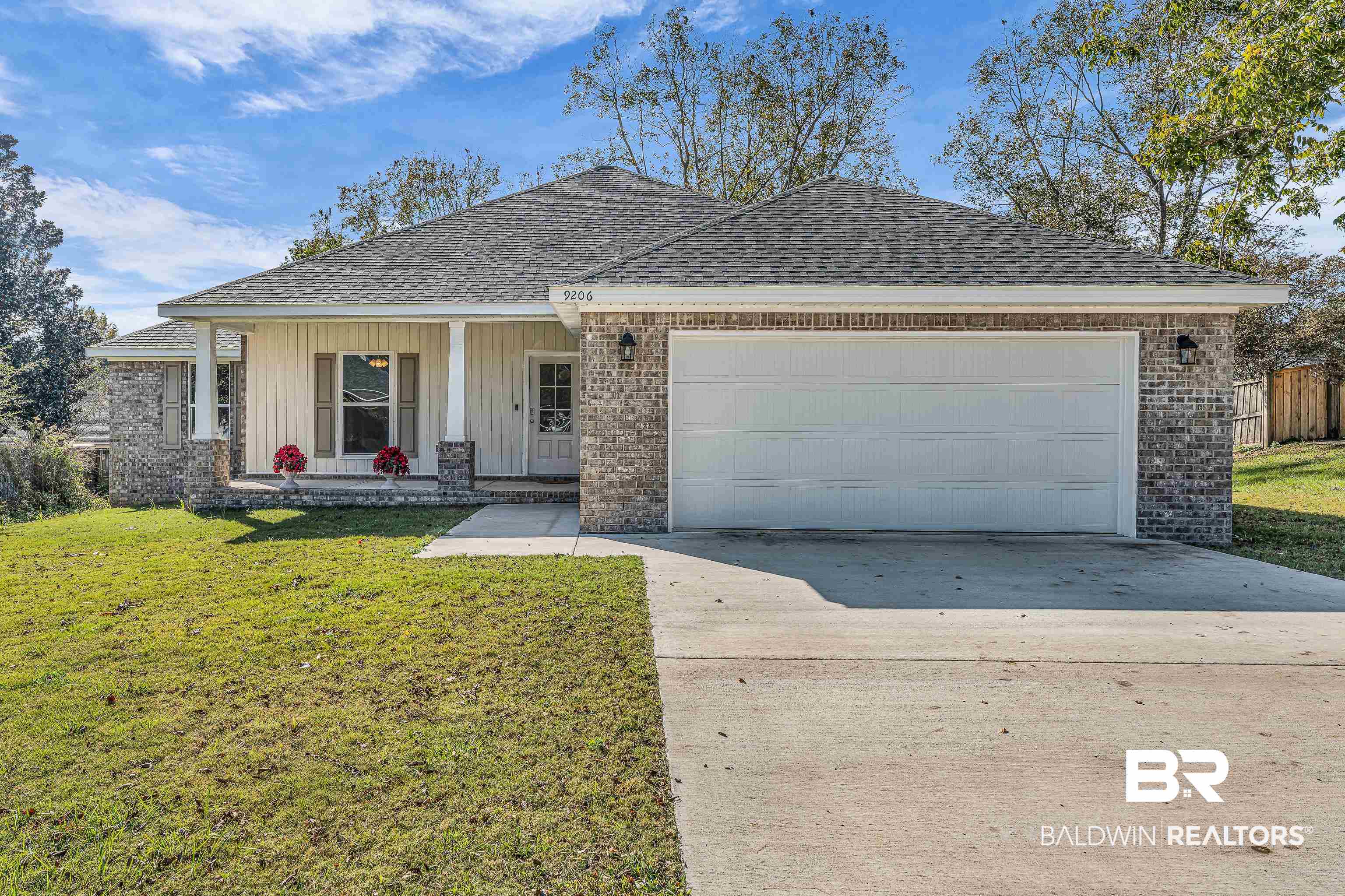 9206 Greenleaf Drive Daphne, AL 36527 - Photo 27 of 32 Single story home featuring brick siding, a porch, a front lawn, and a shingled roof