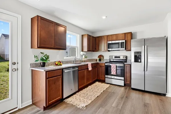 a kitchen with granite countertop a sink and a stove