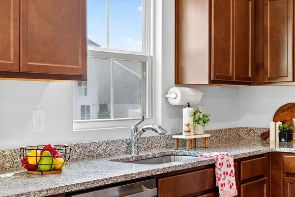 a kitchen with stainless steel appliances granite countertop a refrigerator a stove a sink and dishwasher