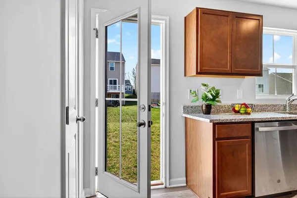 a view of a hallway with wooden cabinet and a refrigerator
