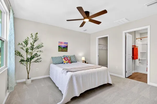 a bedroom with a bed and a mirror