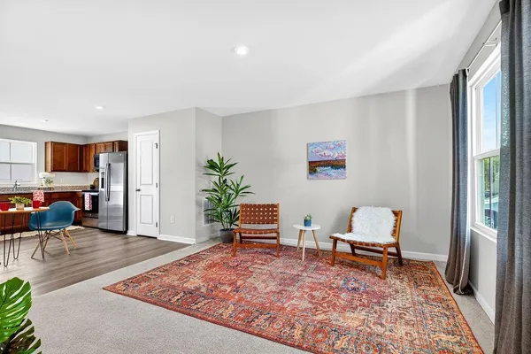 a dining room with furniture and wooden floor