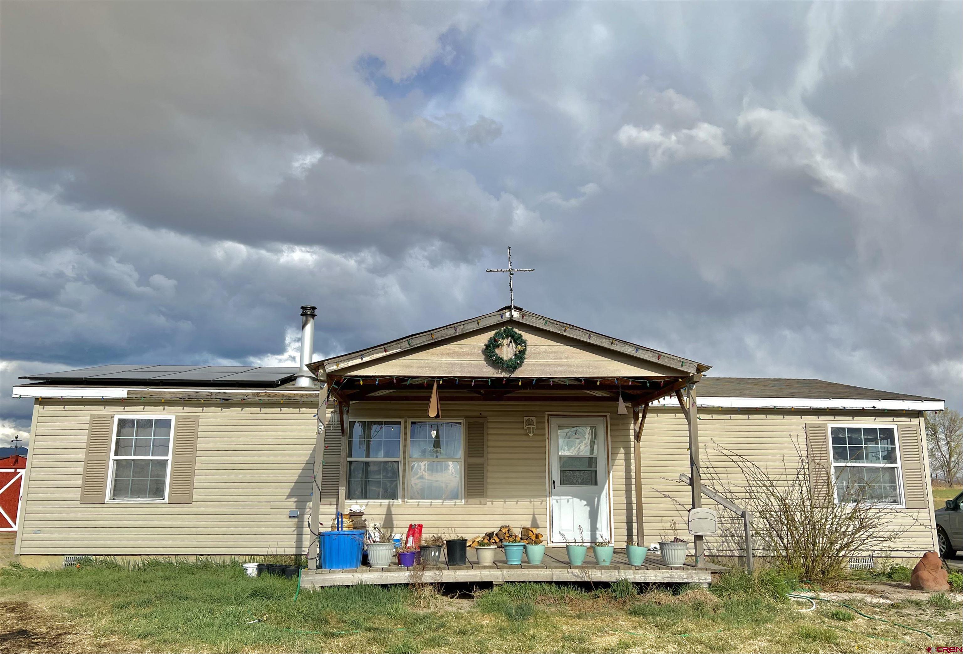 7692 6150th Road Montrose, CO 81401 - Photo 2 of 17 a front view of house with yard