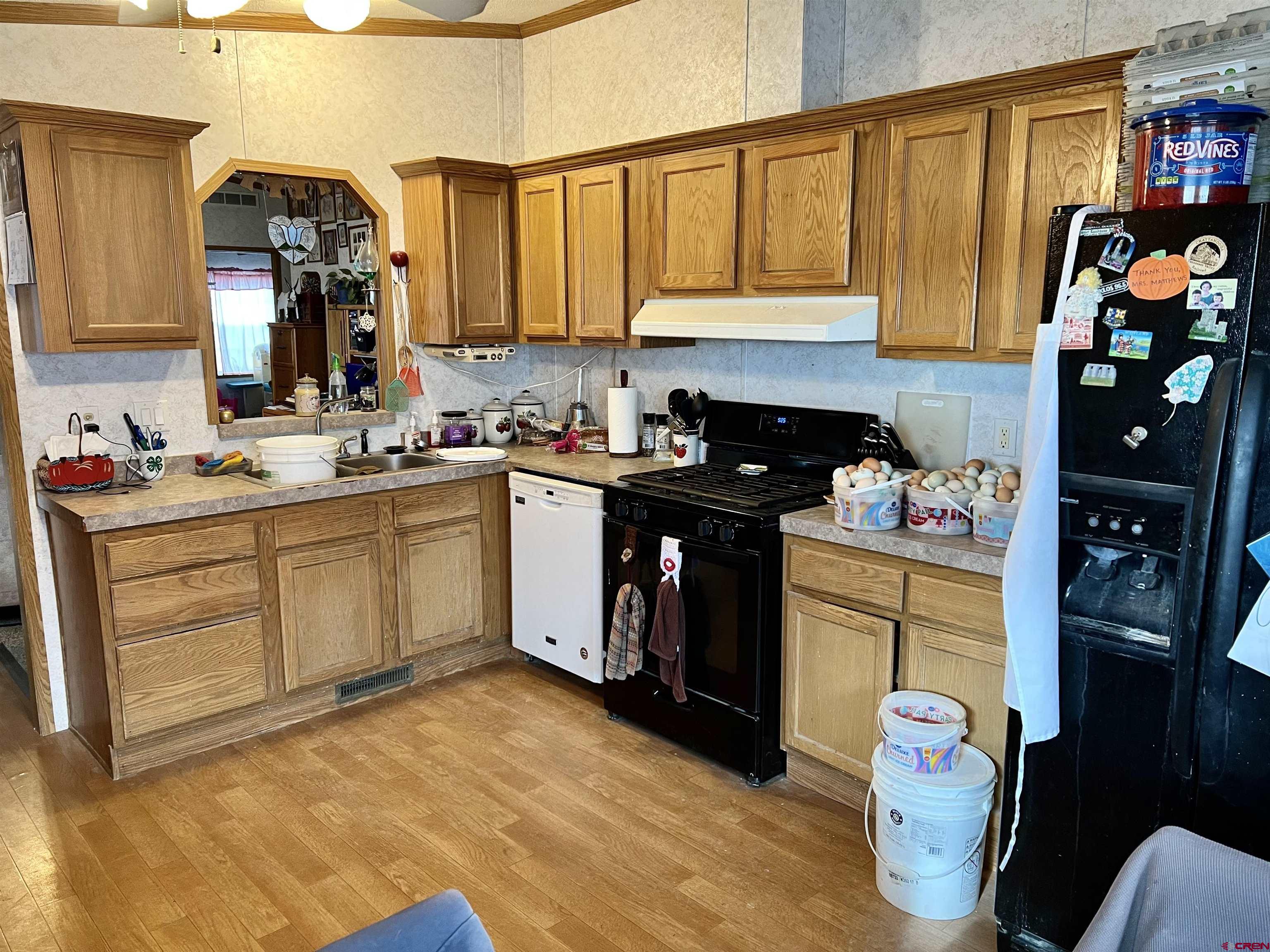 7692 6150th Road Montrose, CO 81401 - Photo 3 of 17 a kitchen with stainless steel appliances granite countertop a sink dishwasher stove and cabinets